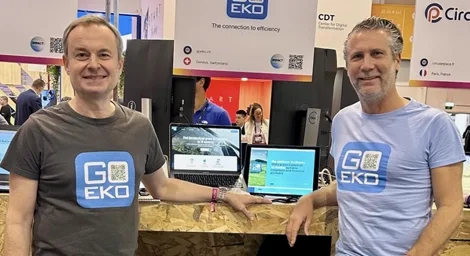 Daniel Eskenazi and Raphaël Herrera at the GoEko stand during a presentation fair, both smiling in branded shirts.