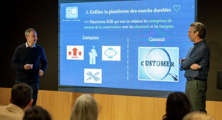 Raphaël Herrera and Daniel Eskenazi presenting the GoEko platform at an event with a large screen behind them.
