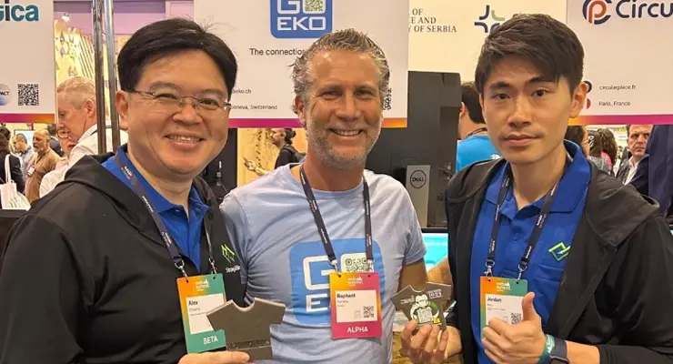 Raphaël Herrera at a sustainability event with two other participants, all smiling and wearing badges.