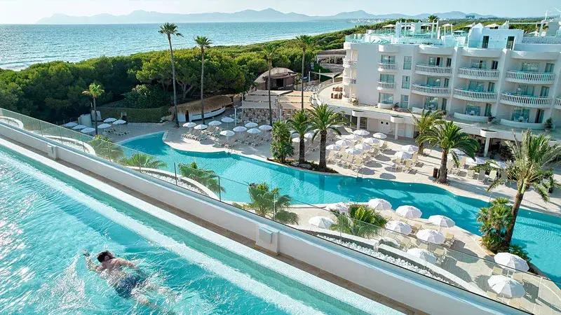 Iberostar resort pool by the sea, surrounded by nature.